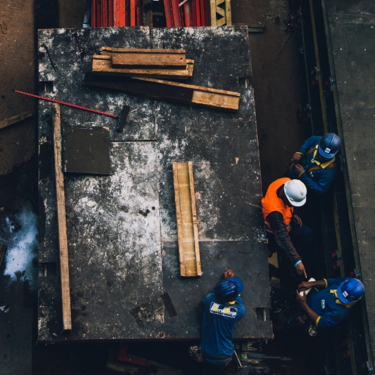 Claims image. Workers in high visibility jackets and hard hats.